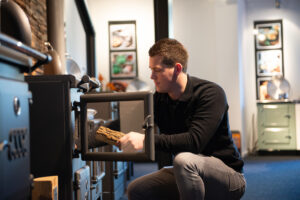 Jelle Jilssen die een houtkachel bijvult van ESSE Cookers